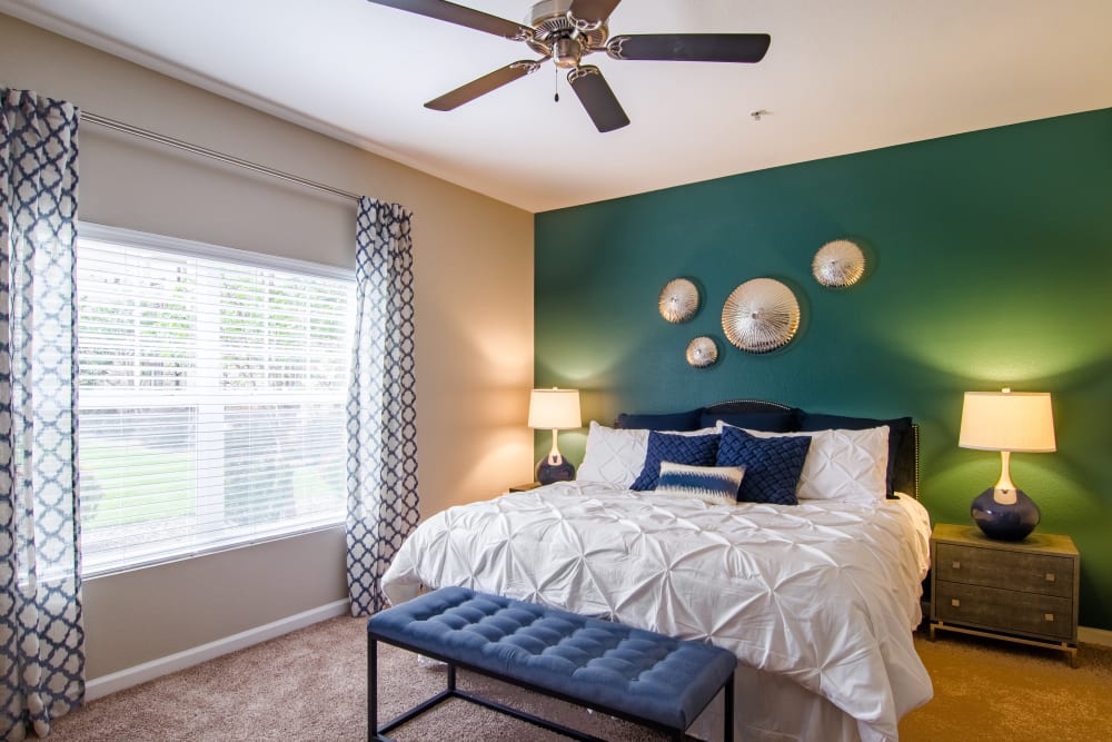 Primary bedroom with large windows at Summit at Flatirons Apartments in Broomfield, Colorado