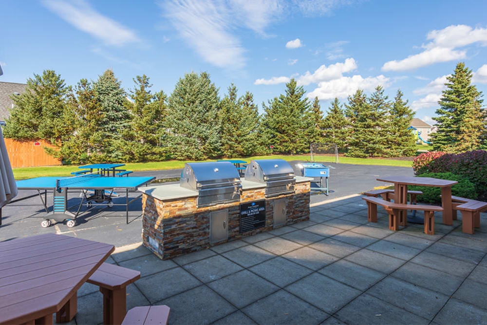 Grilling stations and outdoor games by the swimming pool at Avon Commons in Avon, New York