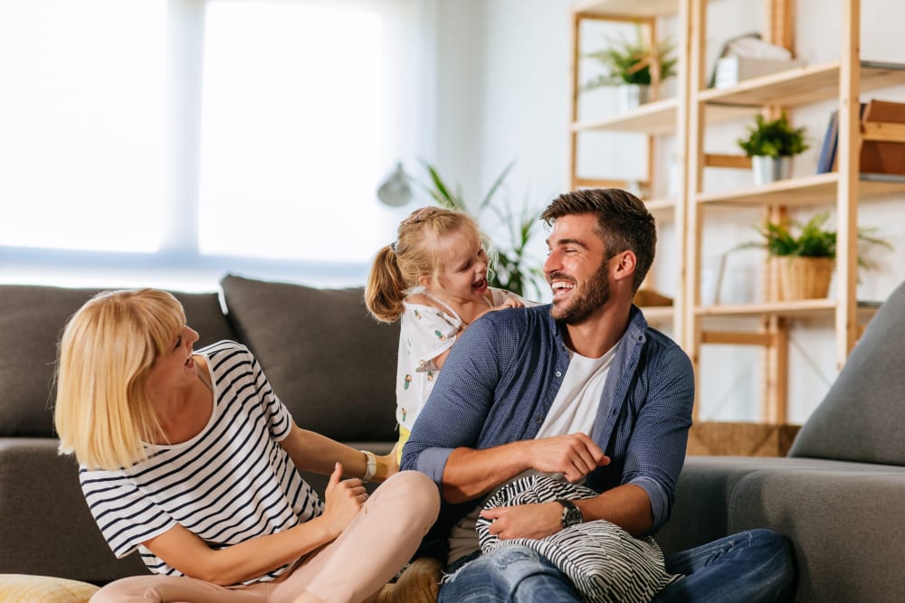 Happy family chatting in their living room at Lakeview Residences in Aurora, Illinois