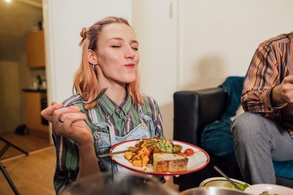 Resident enjoying food in her kitchen at Autumn Ridge in Waukee, Iowa