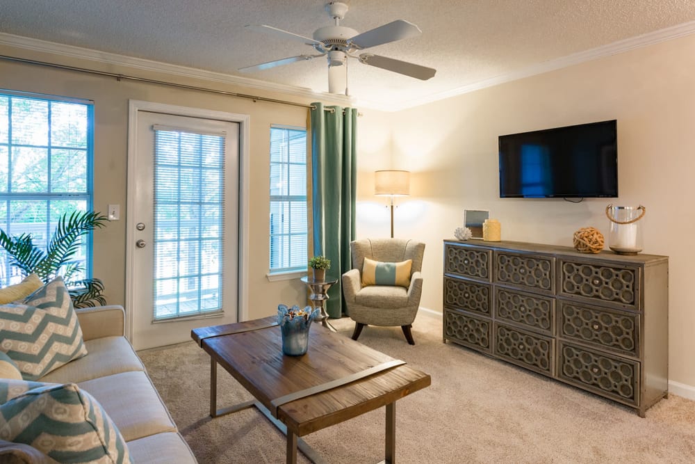 Ceiling fan and plush carpeting in a model home's living area at The Vinings at Newnan Lakes in Newnan, Georgia
