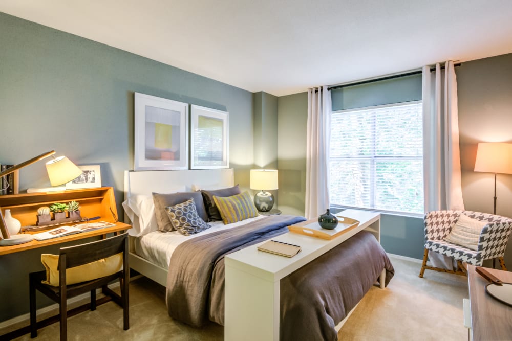 A bedroom with a large window at Residences at Belmont in Fredericksburg, Virginia