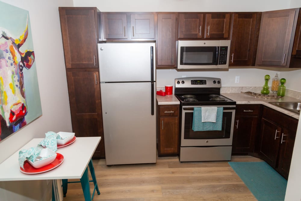 A kitchen with a microwave at Sunbrook Apartments in Saint Charles, Missouri