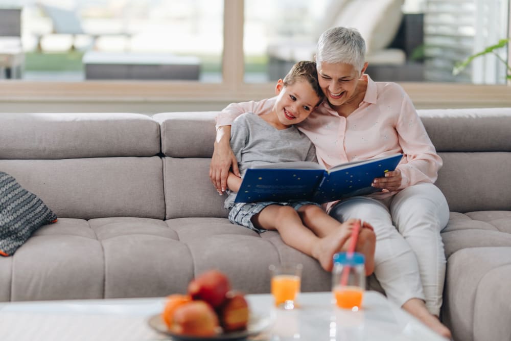 Resident reading to her grandson at Roseville Commons Senior Living in Roseville, California