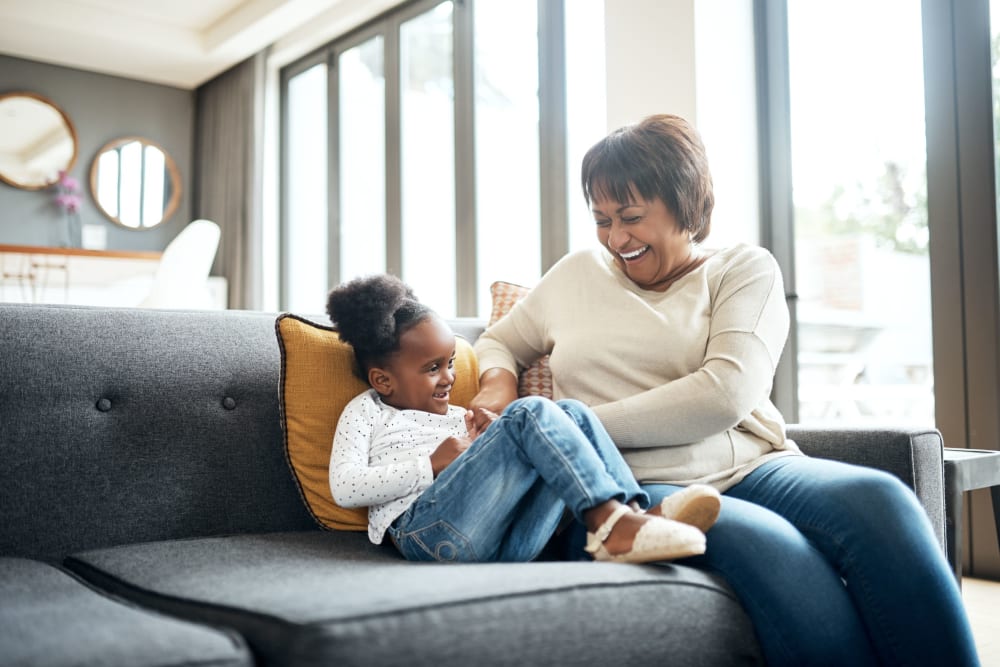 Resident hanging out with her grandchild at Castle Vista Senior Duplex Community in Atwater, California