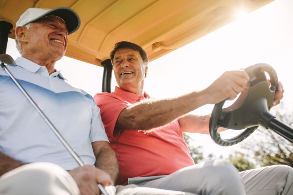 Residents driving a gold cart at a golf course near Leisure Manor Apartments in Sacramento, California