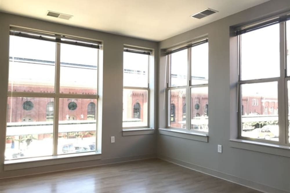 A living room with lots of windows at 770 C Street Apartments in Washington, District of Columbia
