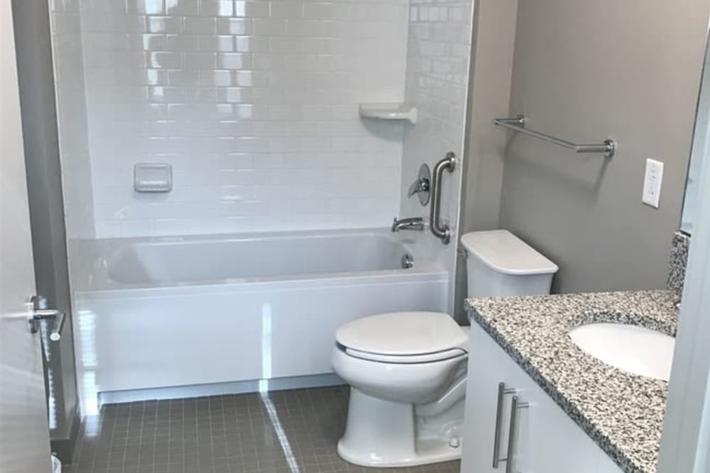 A bathroom with an oval tub at 770 C Street Apartments in Washington, District of Columbia