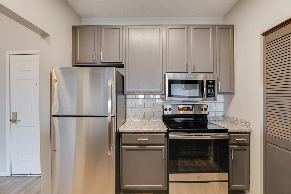 A kitchen with a stainless-steel fridge at Provence Apartments in Burnsville, Minnesota