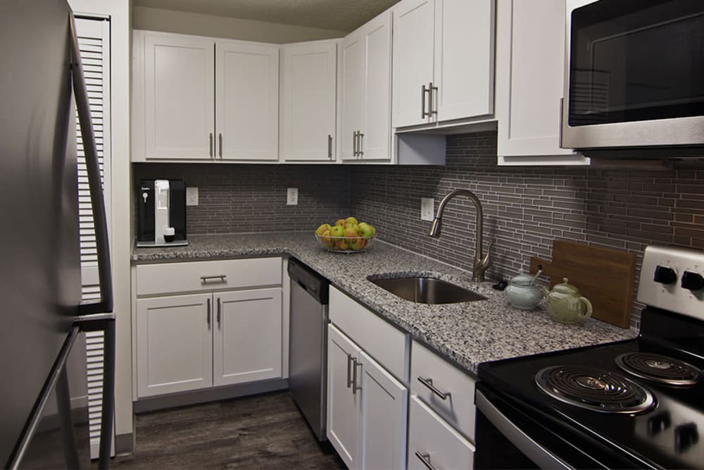 Contemporary kitchen with white Shaker cabinetry and stainless-steel appliances at Westpointe Apartments in Pittsburgh, Pennsylvania