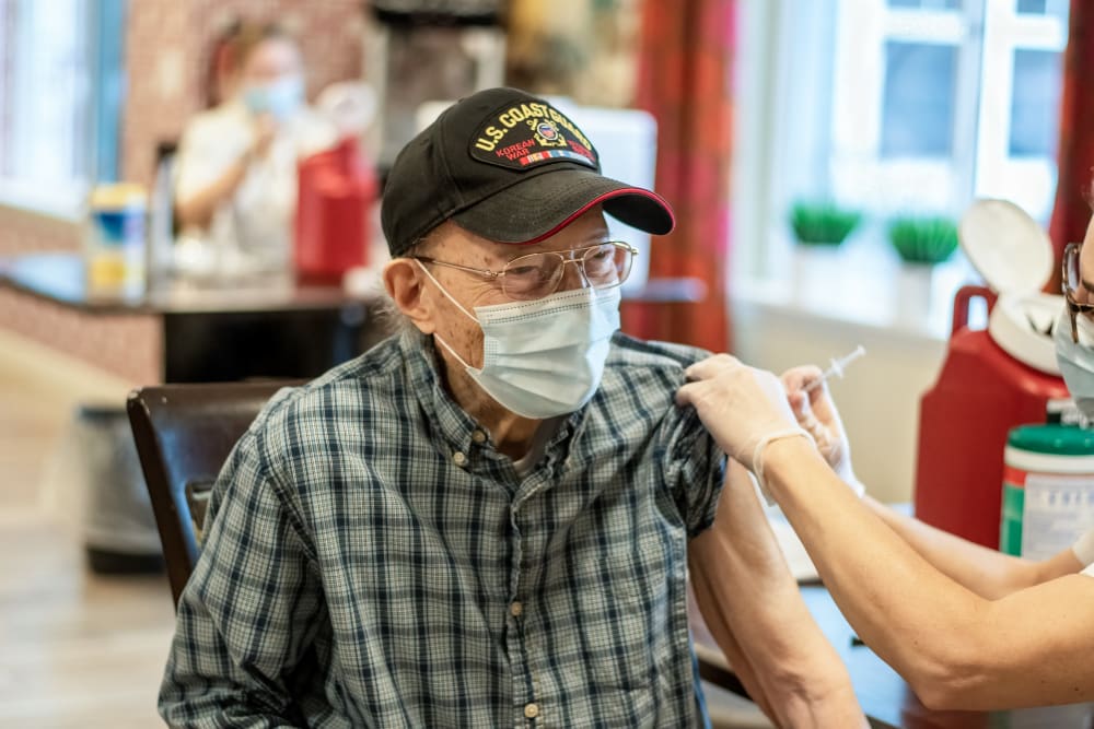 senior resident receiving a vaccine