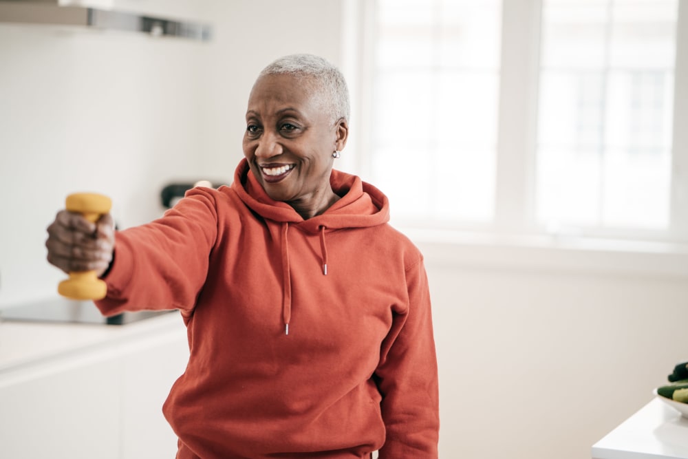 Resident lifting a dumbbell at Bateswood Manor in Houston, Texas