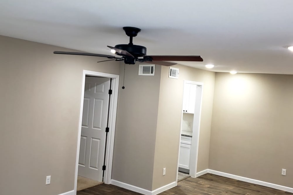 Living room with a ceiling fan at Bateswood Manor in Houston, Texas