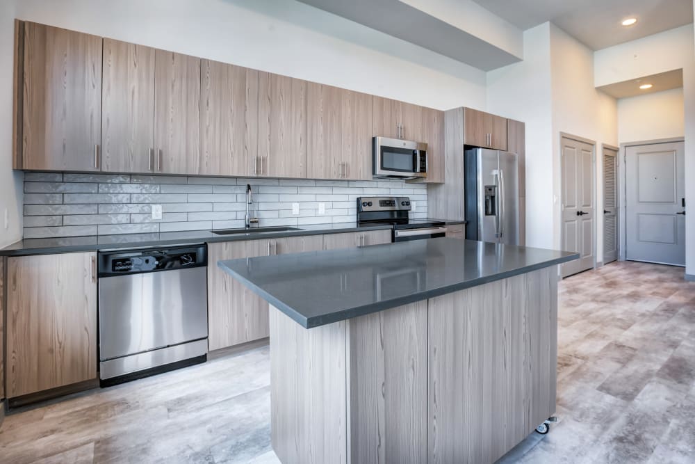 Kitchen with large island at The District Flats in West Palm Beach, Florida