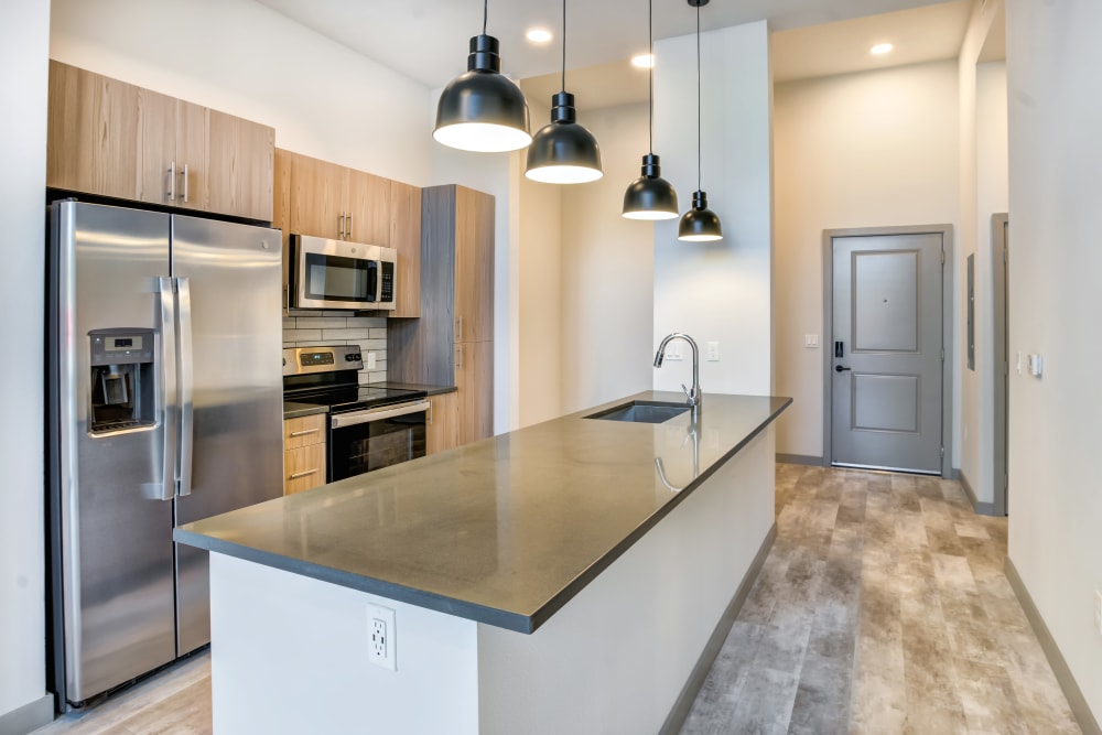 Stainless-steel appliances in expansive kitchen at The District Flats in West Palm Beach, Florida