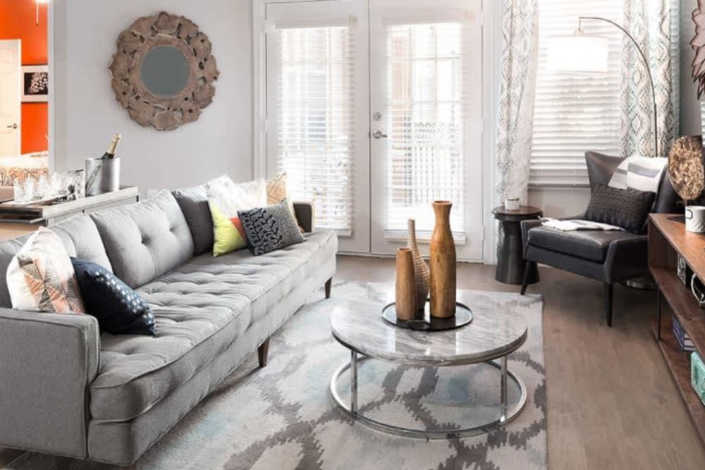 Living room with wood style flooring at Alesio Urban Center in Irving, Texas