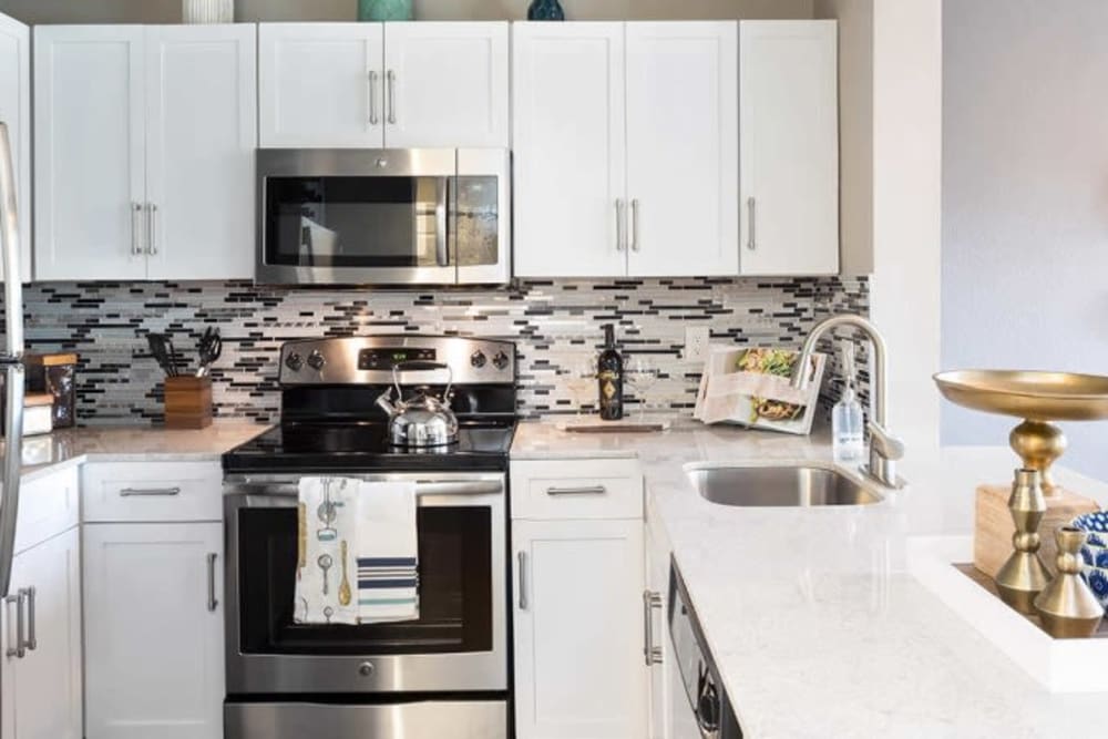 Bright kitchen with subway tile at Alesio Urban Center in Irving, Texas