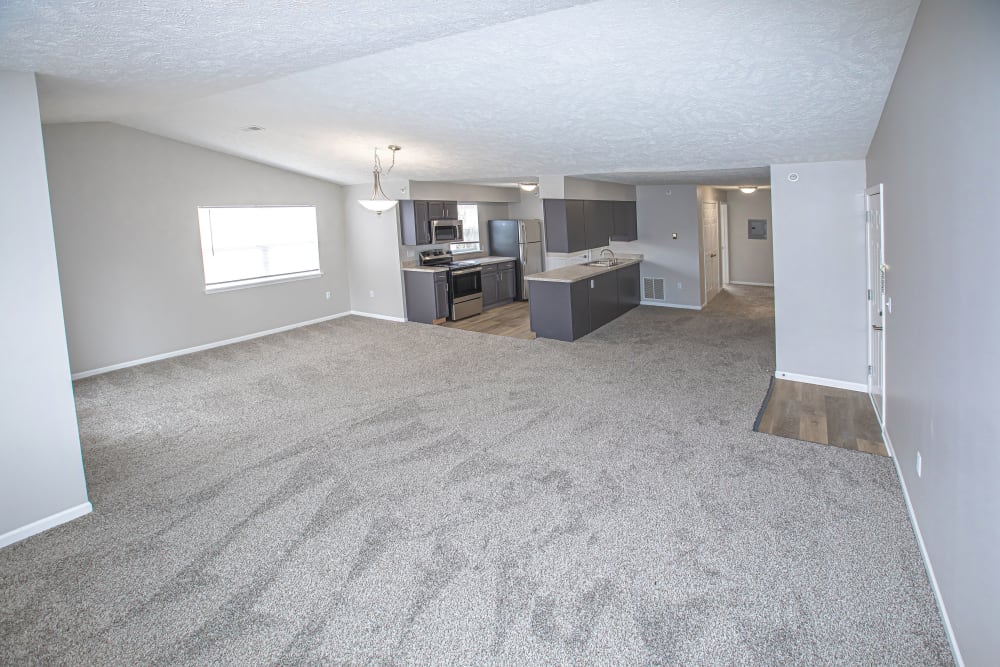 A large living room with plush carpeting at Silver Lake Hills in Fenton, Michigan
