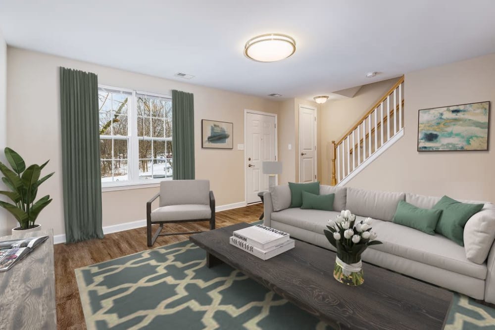 A spacious living room with wood-style flooring at Greenhills Apartments & Townhomes in Damascus, Maryland