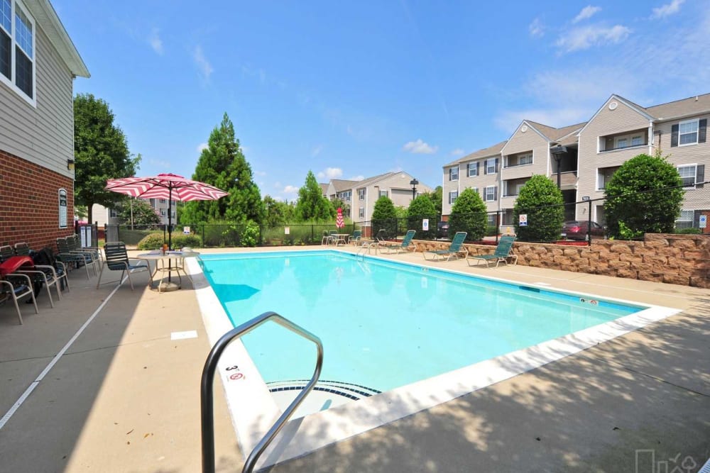 A swimming pool with lounge chairs at Lieutenant's Run in Petersburg, Virginia
