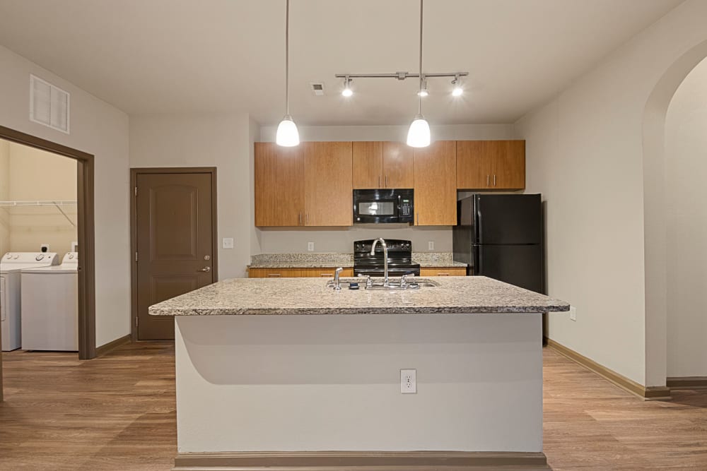 Kitchen with a breakfast bar at The Addison at South Tryon in Charlotte, North Carolina