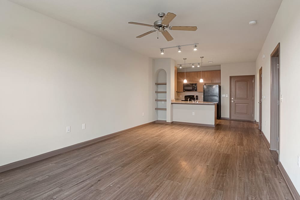 Large living room with plush carpeting and a ceiling fan at The Addison at South Tryon in Charlotte, North Carolina