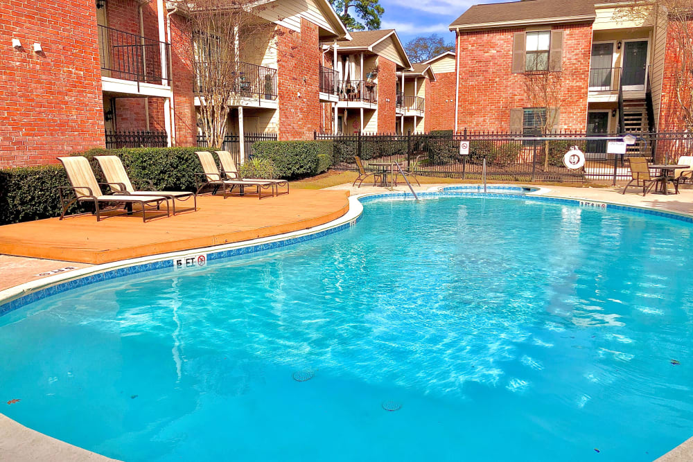 Swimming pool area at The Abbey at Montgomery Park in Conroe, Texas