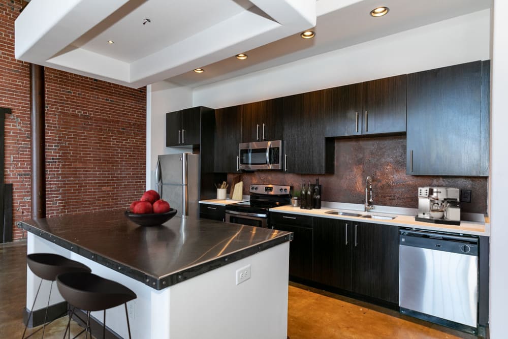 Kitchen with stainless steel appliances at The Lofts at Swift Mill in Columbus, Georgia