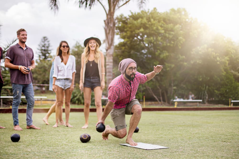 Friends lawn bowling near Ikon Athens in Athens, Georgia
