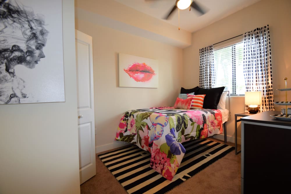 Nicely decorated bedroom with large window and ceiling fan at University Park in Boca Raton, Florida