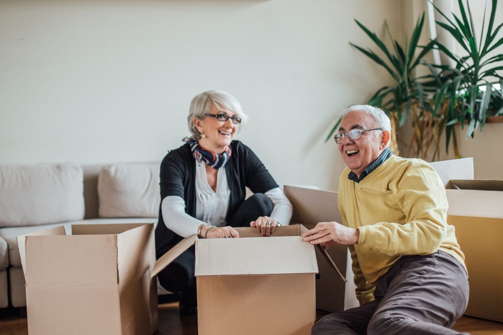 Two smiling senior citizens getting ready to store some belongings at Trojan Storage of Salinas Blanco in Salinas, California