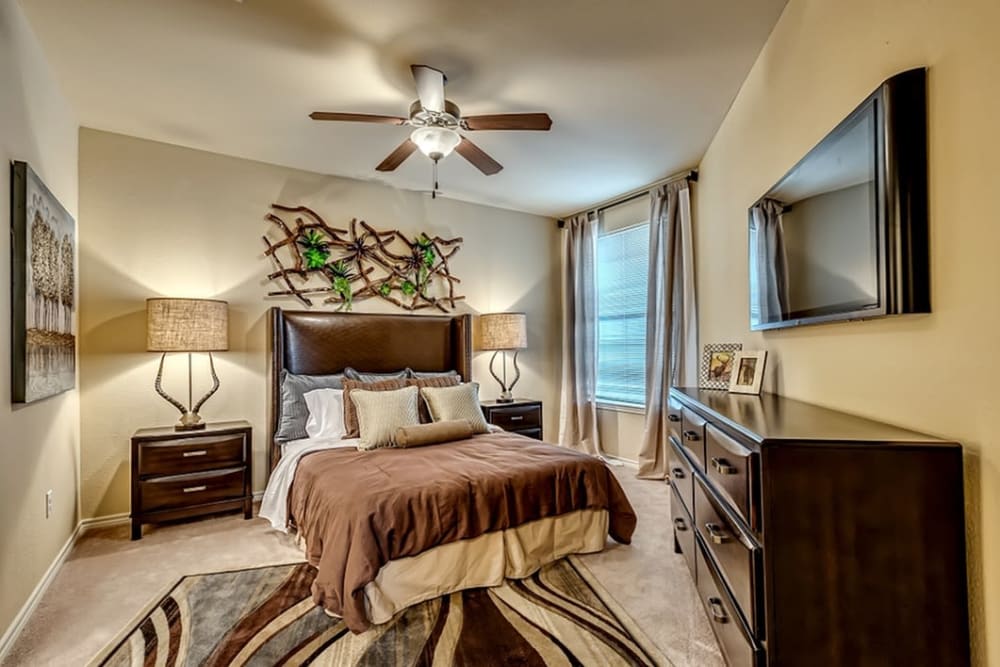 Spacious model bedroom with plush carpeting at Chateau Mirage Apartment Homes in Lafayette, Louisiana