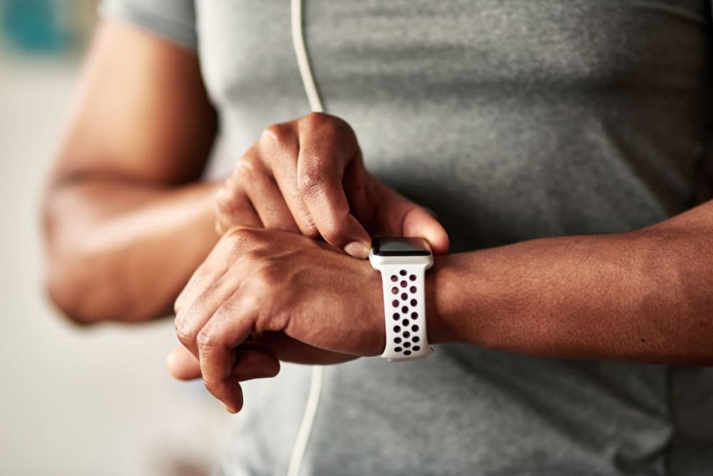 Resident checking his watch while working out at the fitness center at The Cambridge Apartments in Washington, District of Columbia