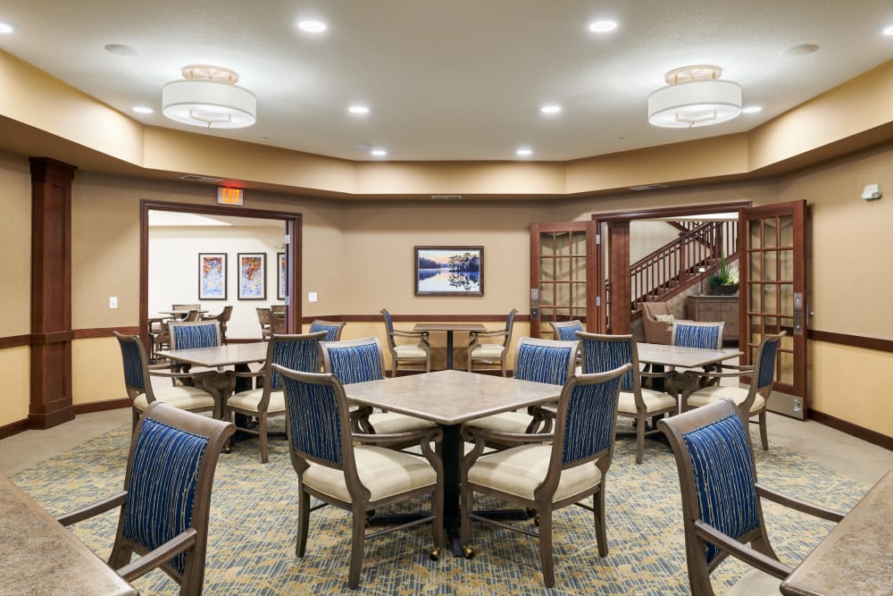 Room with tables and chairs at Willows Landing in Monticello, Minnesota
