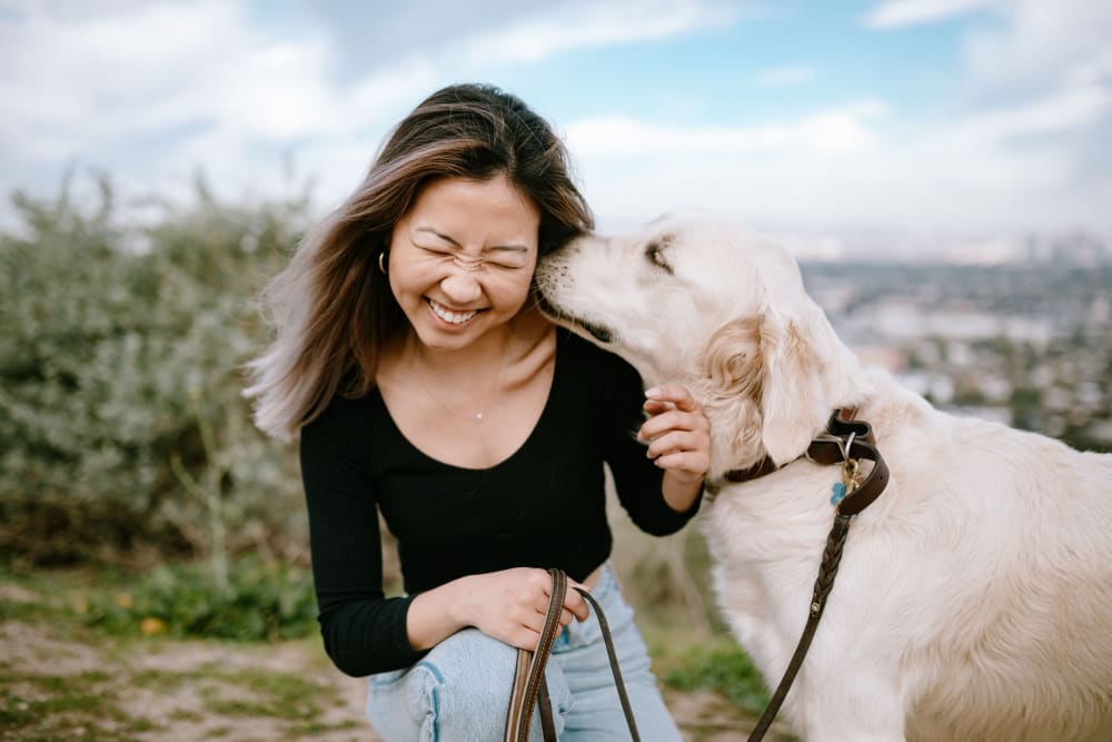 Happy resident with dog at Meritage Apartments in Lodi, California