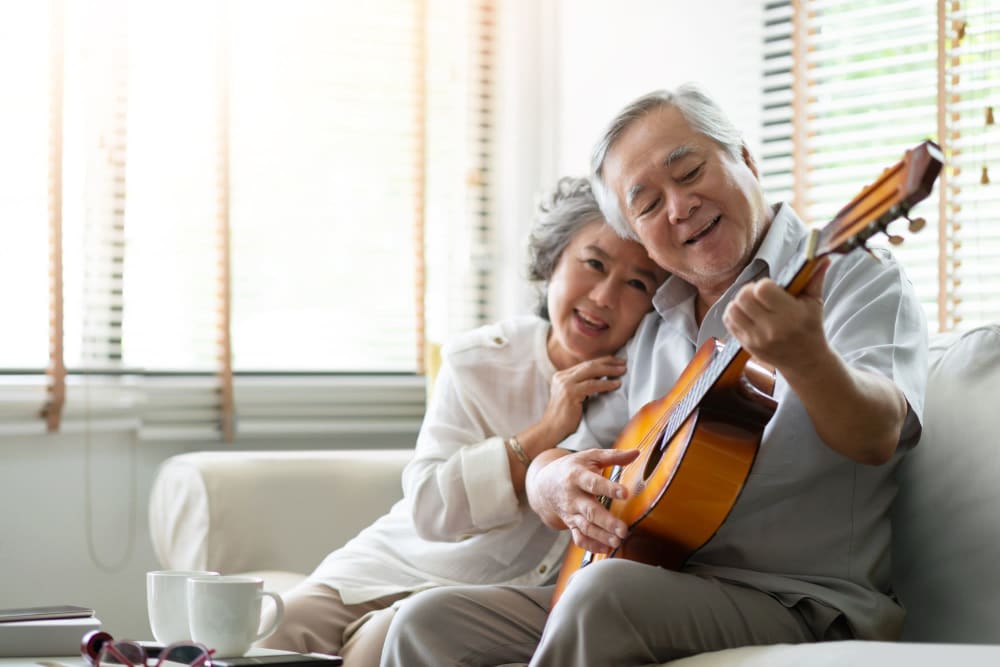 Resident playing guitar for his wife at Leisure Manor Apartments in Sacramento, California