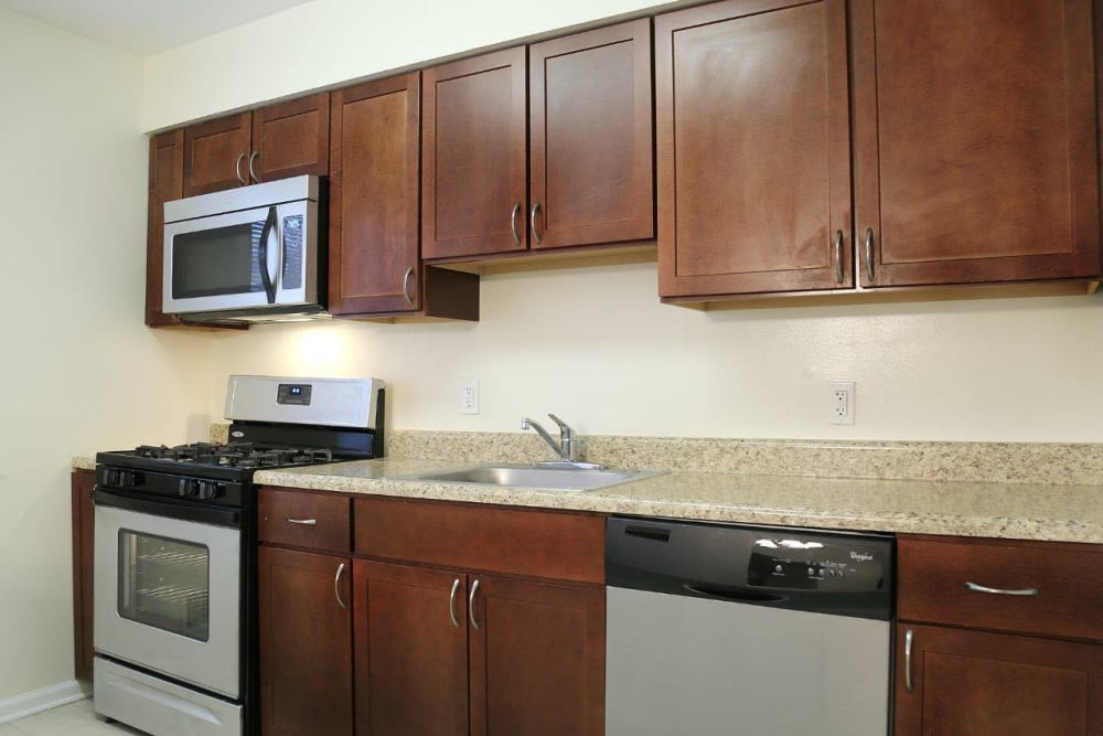 Wood style cabinets in the kitchen with tons of space on counters for cooking and baking at Eagle Rock Apartments at North Plainfield in North Plainfield, New Jersey