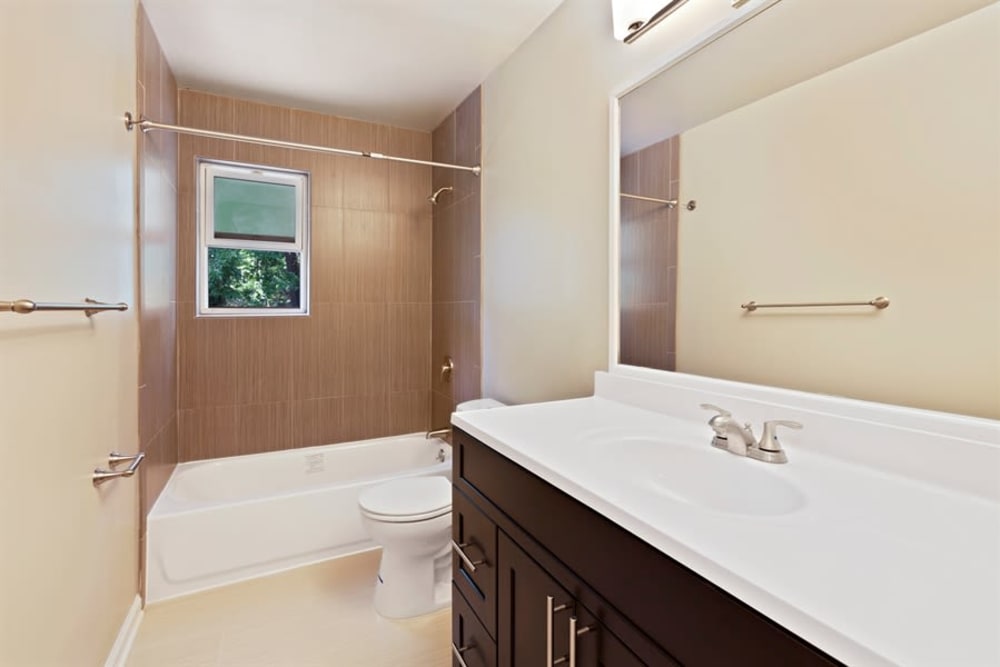 Spacious bathroom with window for some natural light while showing in the morning at Eagle Rock Apartments at North Plainfield in North Plainfield, New Jersey