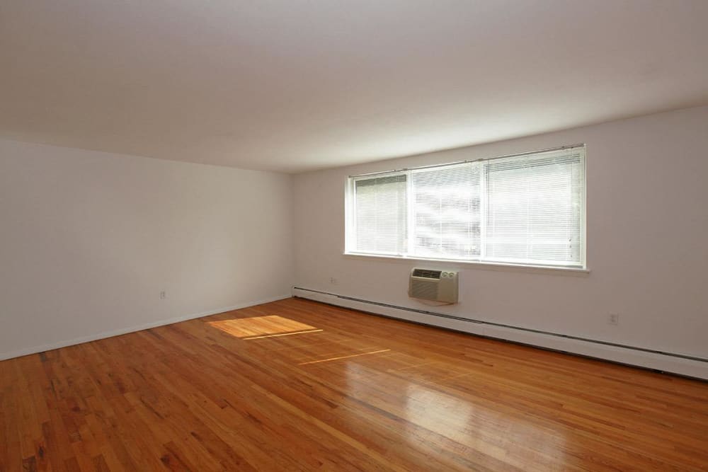 Living room area with lots of light and wood style flooring at Eagle Rock Apartments at West Hartford in West Hartford, Connecticut