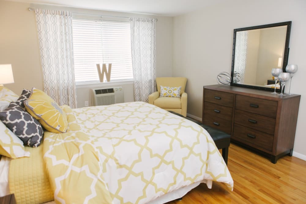 Decorated bedroom with wood flooring at Eagle Rock Apartments at West Hartford in West Hartford, Connecticut