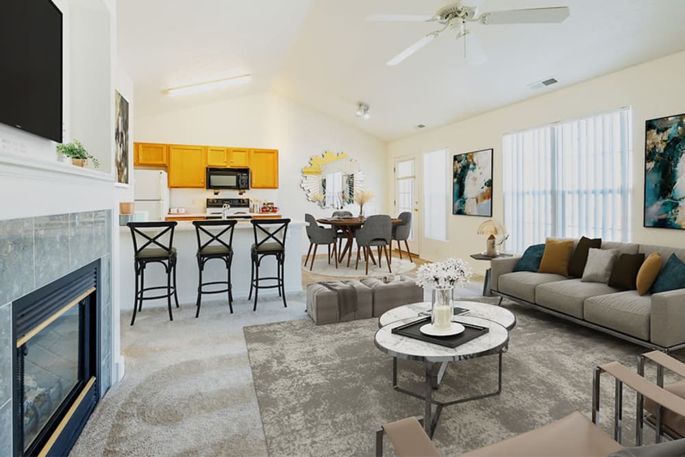 Kitchen and spacious living area with a fireplace at Avon Commons in Avon, New York