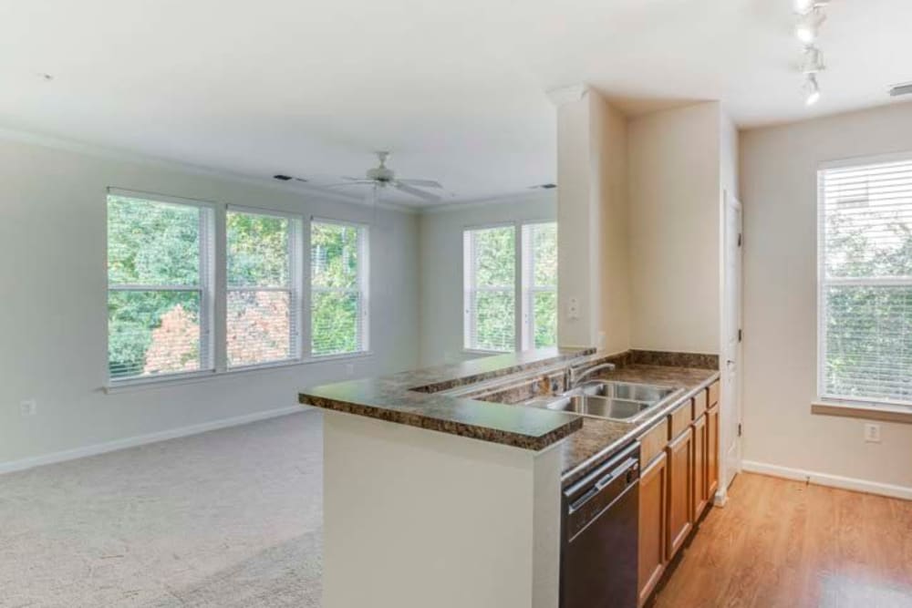 Empty kitchen with breakfast bar and lots of windows for tons of natural light at Summerfield at Morgan Metro in Landover, Maryland