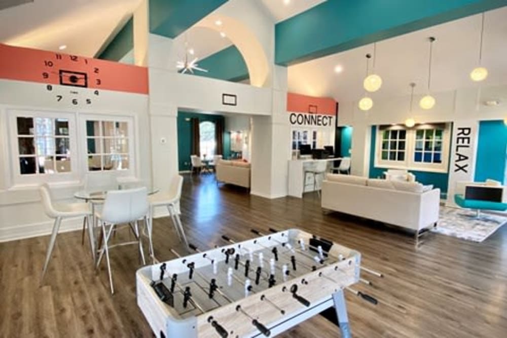Game room with a foosball table and more in the resident clubhouse at 1801 MetroWest in Orlando, Florida