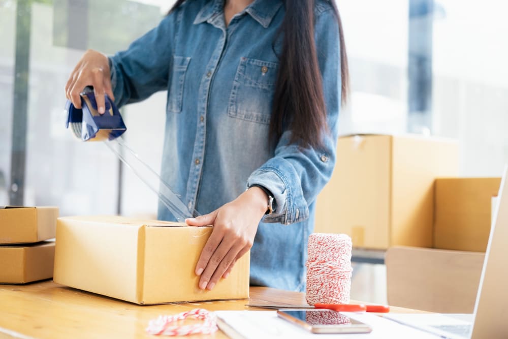 A woman packing boxes near Storage Star Laredo in Laredo, Texas