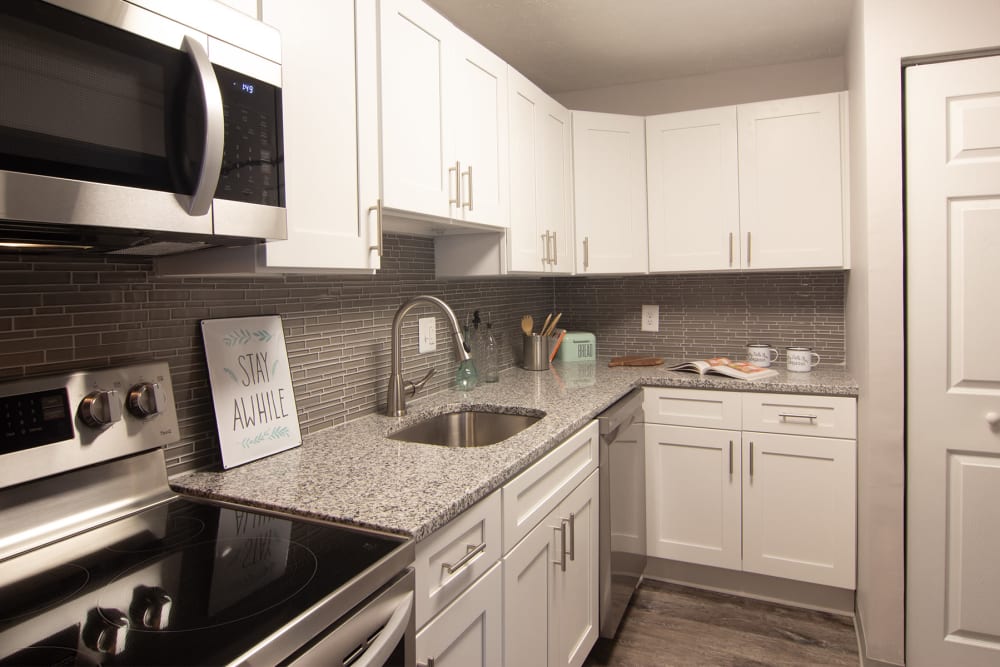 Kitchen with stainless-steel appliances and white cabinets at Park Place of South Park in South Park, Pennsylvania