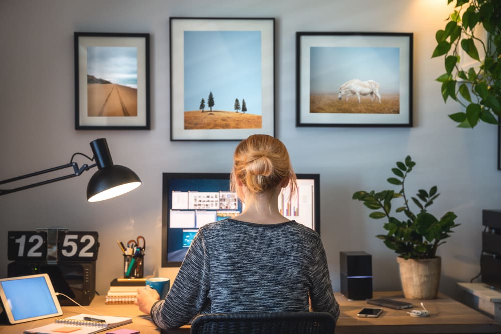 Woman working on a computer at her office at The Planet in Toronto, Ontario