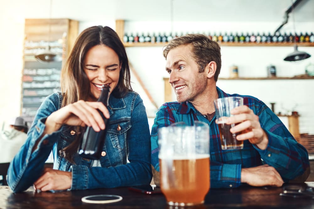 Two friends enjoying a beer at a local restaurant near The Planet in Toronto, Ontario