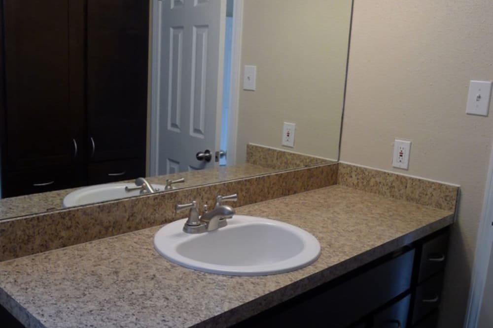 Bathroom with tons of counter space and large mirror at 10501 Holly Springs in Houston, Texas