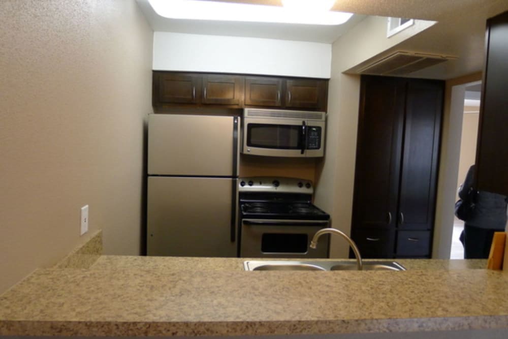 Kitchen with breakfast bar for extra counter space at 10501 Holly Springs in Houston, Texas