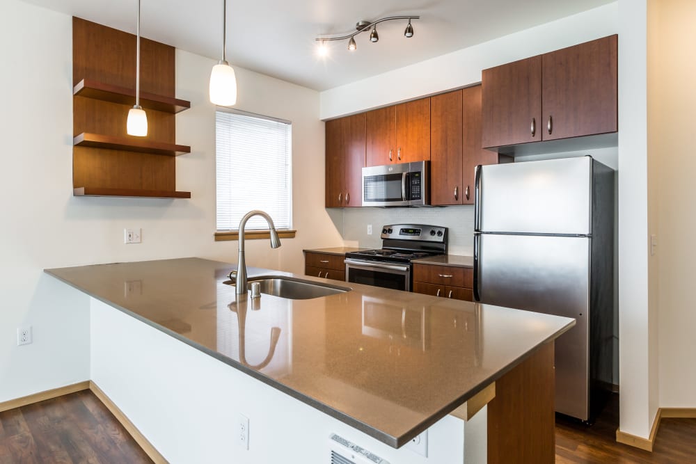 Kitchen with granite counters at Marq West Seattle in Seattle, Washington